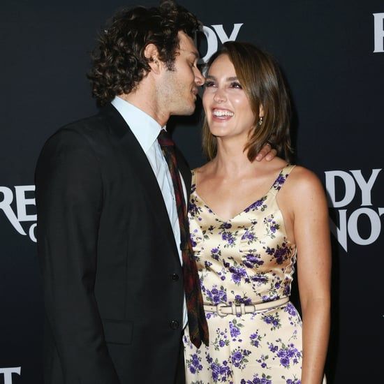 a man and woman standing next to each other on a red carpet with the words dryer's hot in front of them