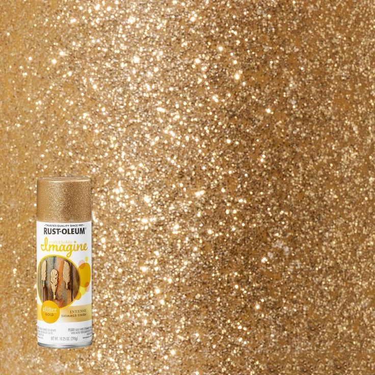 a can of paint sitting on top of a glittery surface with gold flakes
