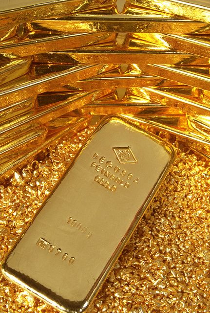a gold bar sitting on top of a pile of gold