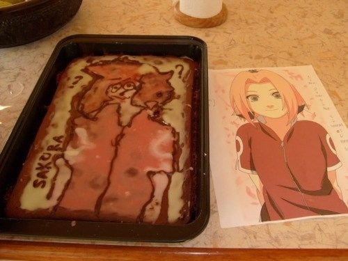 a sheet cake sitting on top of a pan next to a card with an anime character