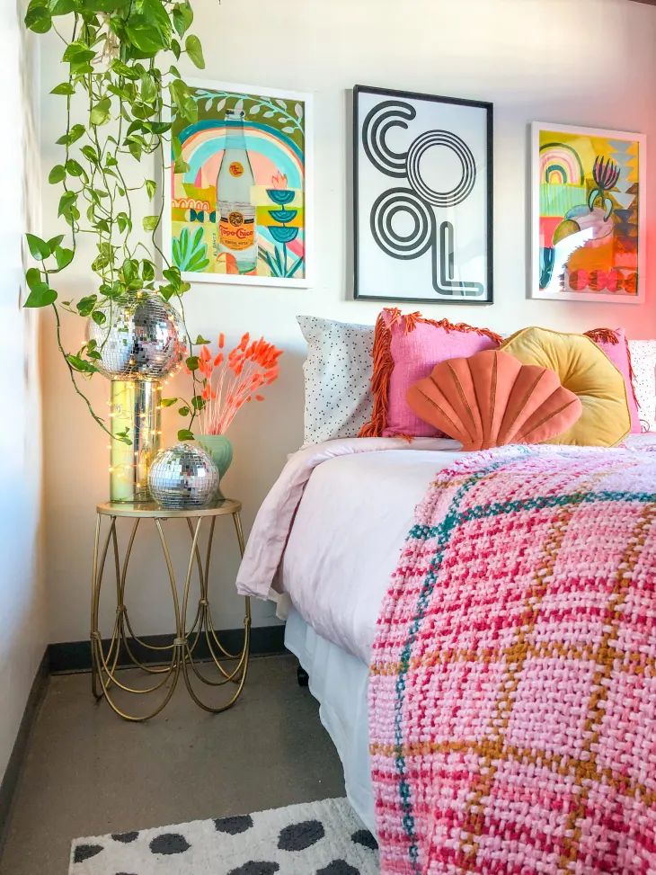 a bedroom with art on the wall and a bed in it's centerpiece