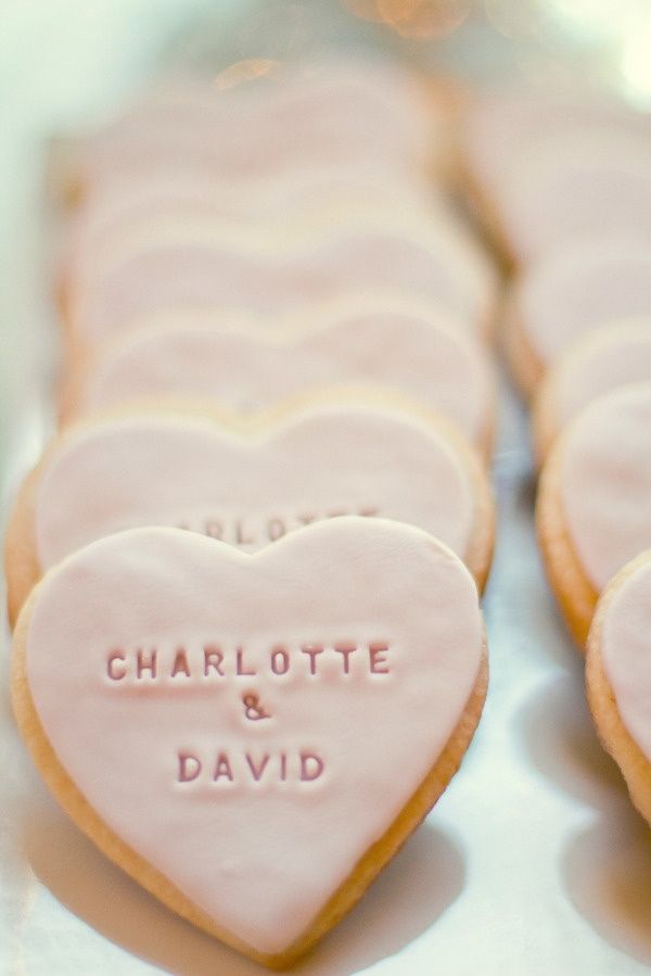 heart shaped cookies with names on them sitting next to each other in the shape of hearts