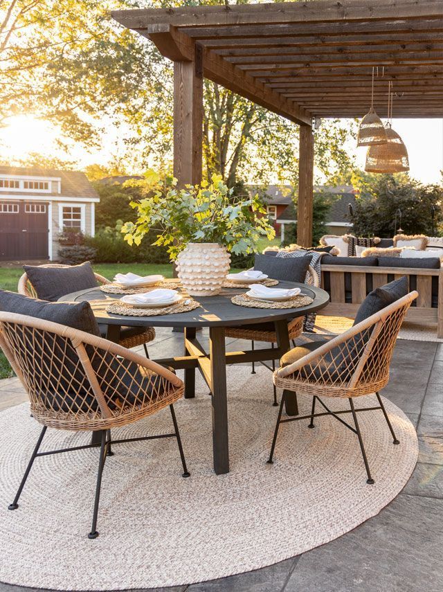 an outdoor dining area with chairs and table