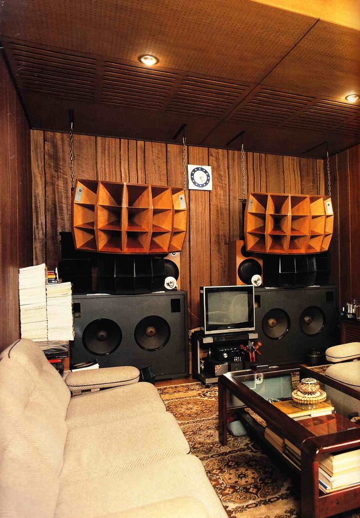 a living room filled with furniture and speakers