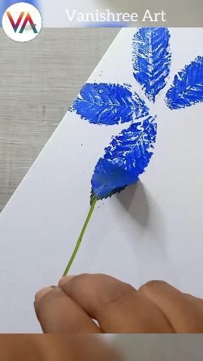 someone is drawing a blue flower on white paper