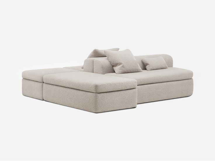 a large sectional couch with pillows on it's back and the seat folded down