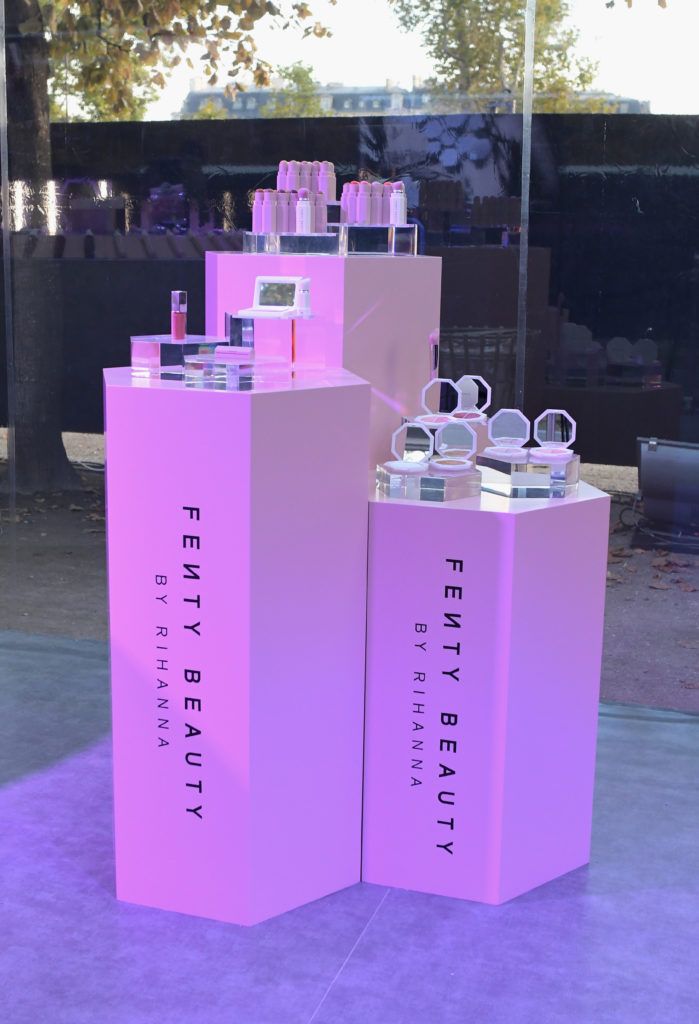 two pink display cases sitting on top of a purple floor next to each other in front of a window