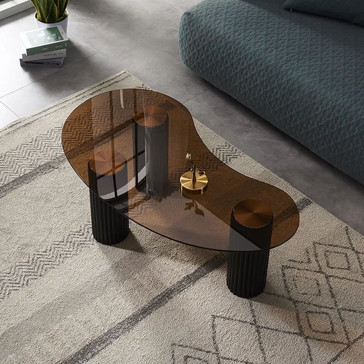 a glass coffee table sitting on top of a rug