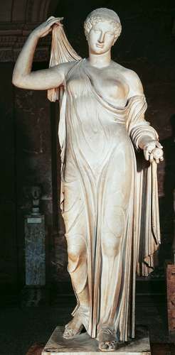a statue of a woman with her hands in her hair, standing on a pedestal