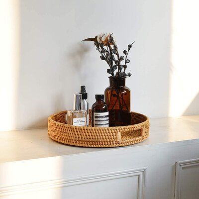 a wicker basket with bottles and flowers in it sitting on a white countertop