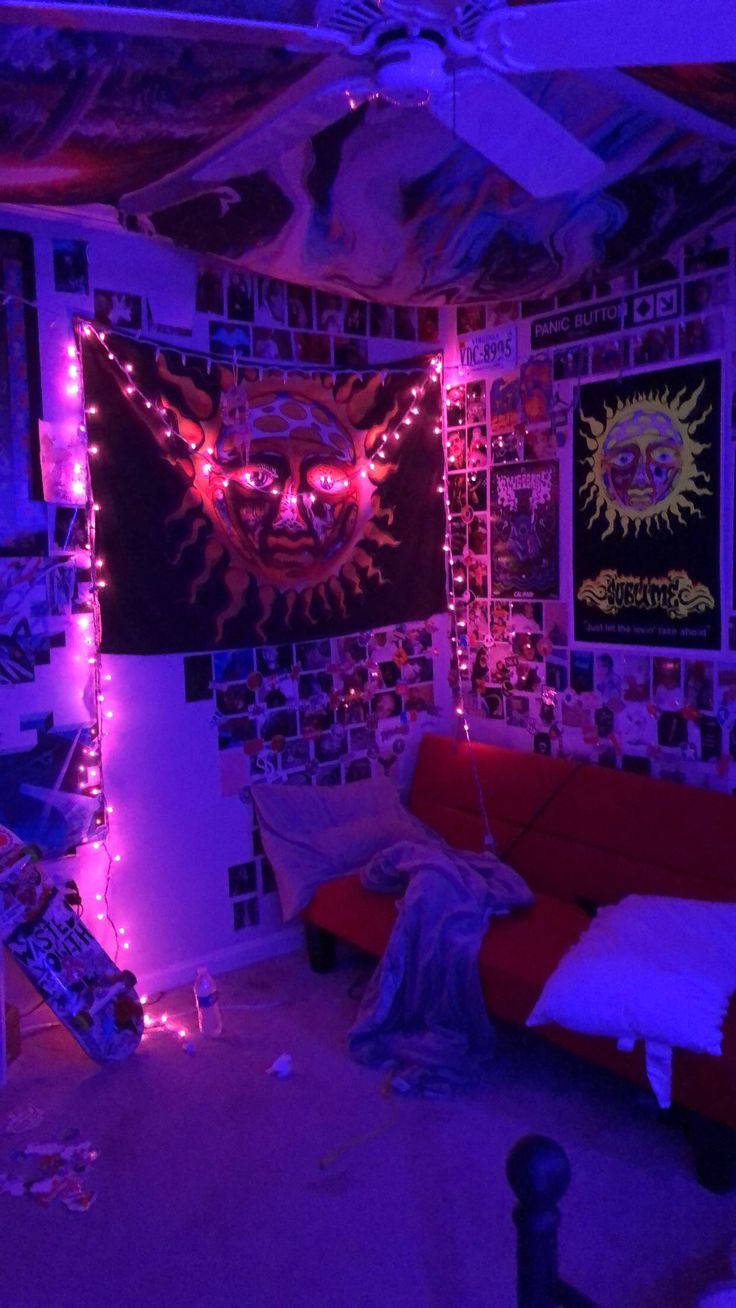 a living room with purple lights and pictures on the wall above the red couches
