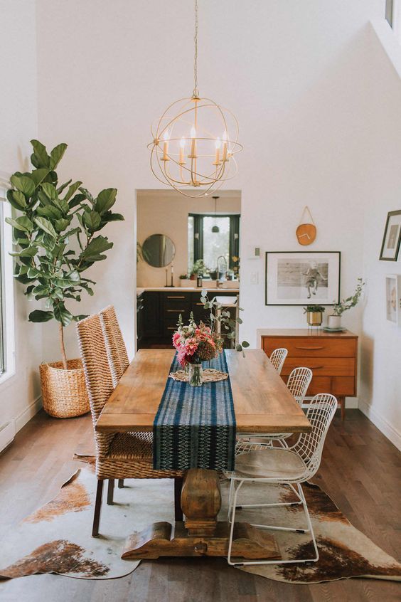 an instagram photo of a dining room table with chairs and a potted plant
