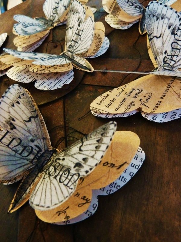 several butterflies are sitting on top of a wooden table with words written on them and some type of writing attached to the wings