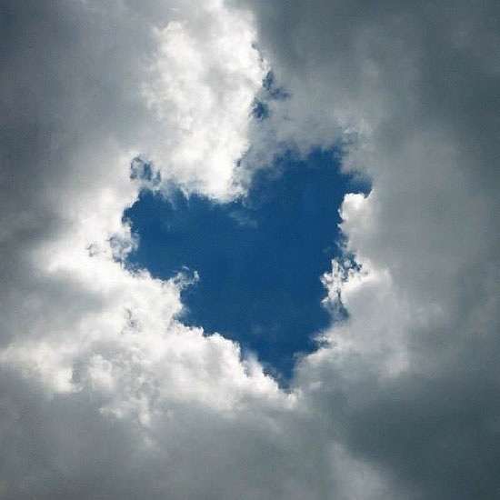 a blue heart shaped cloud in the sky