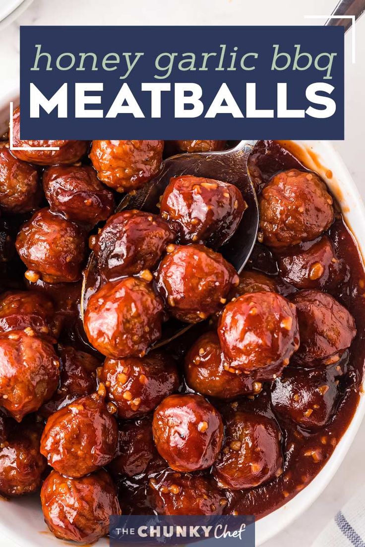 a white bowl filled with meatballs covered in bbq sauce and topped with a spoon