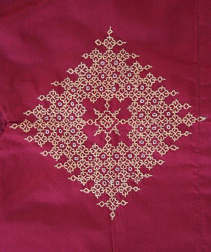 an embroidered red cloth with gold threadwork