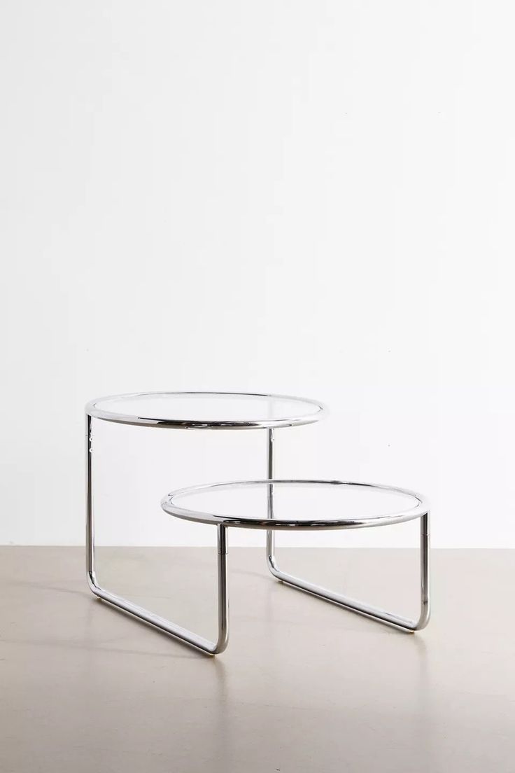 two glass tables sitting on top of a table
