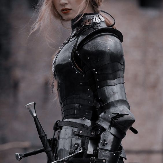 a woman dressed in black holding two swords