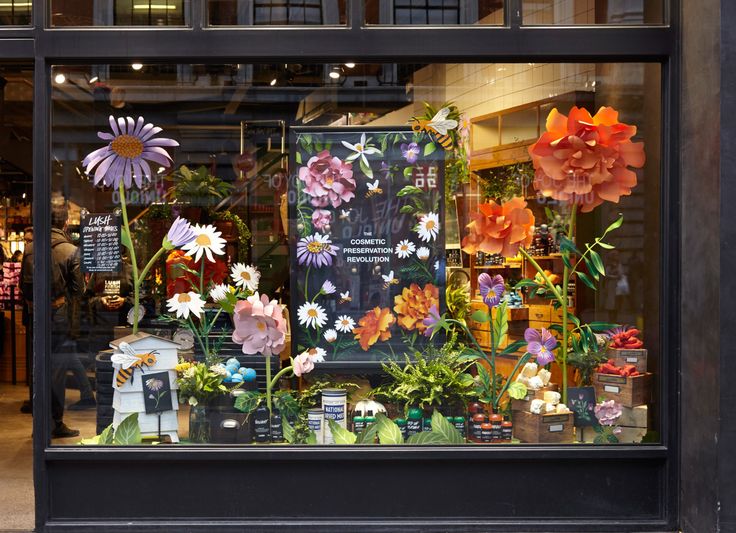 a store window with fake flowers in it