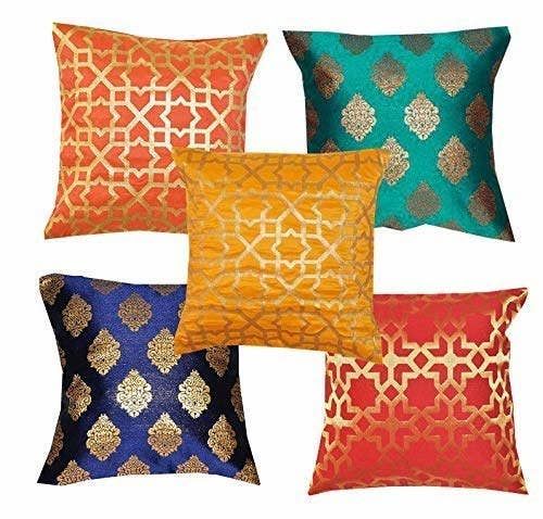 four different colored pillows on a white background