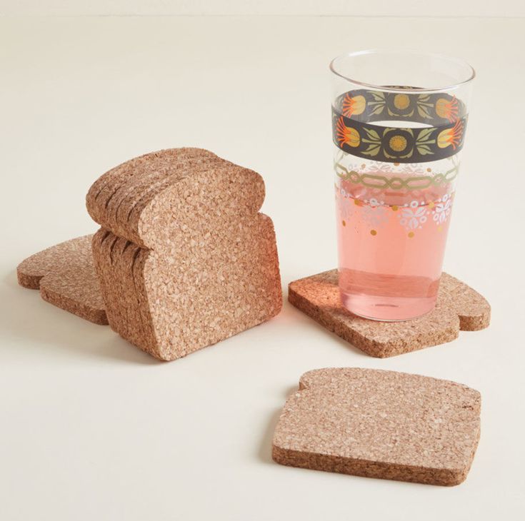 two pieces of bread are next to a glass of water and some slices of toast