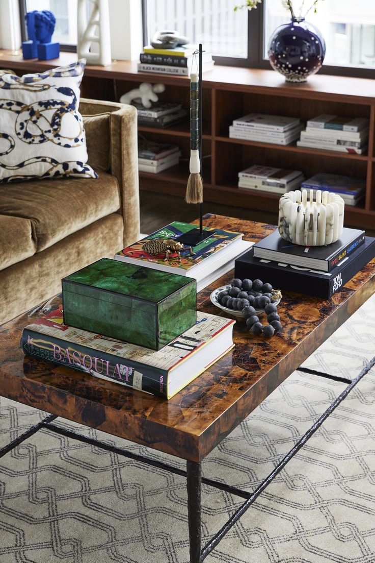 a coffee table with books and candles on it