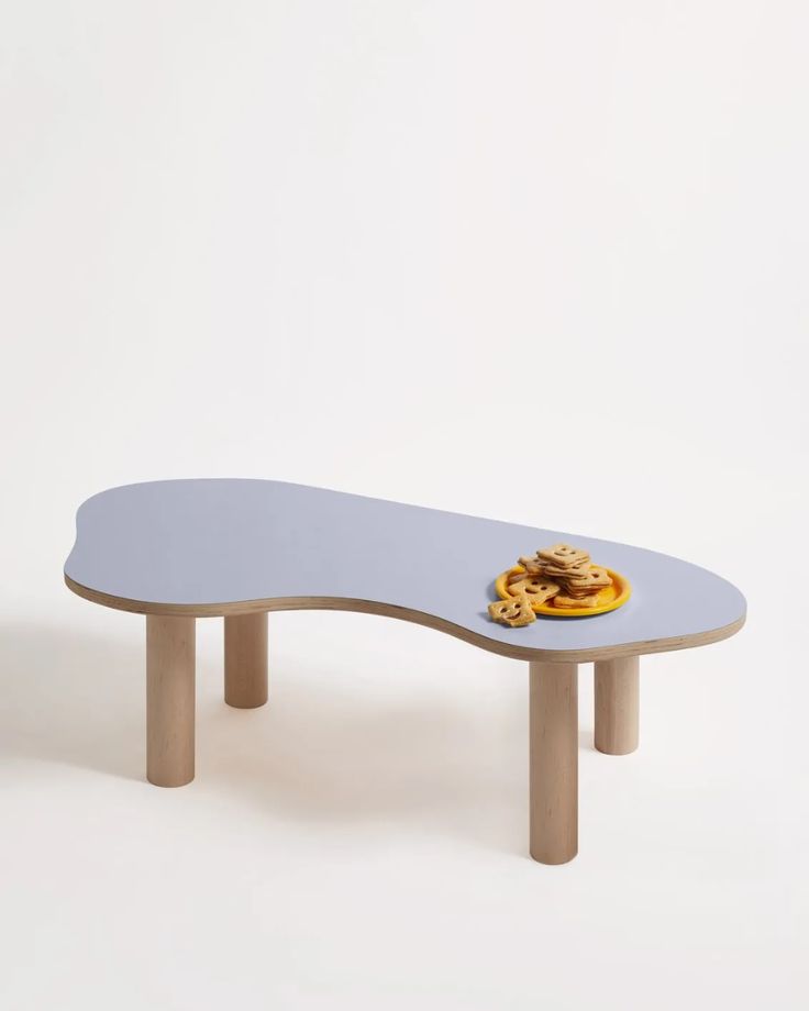 a skateboard shaped table with cookies on the top and bottom, in front of a white background