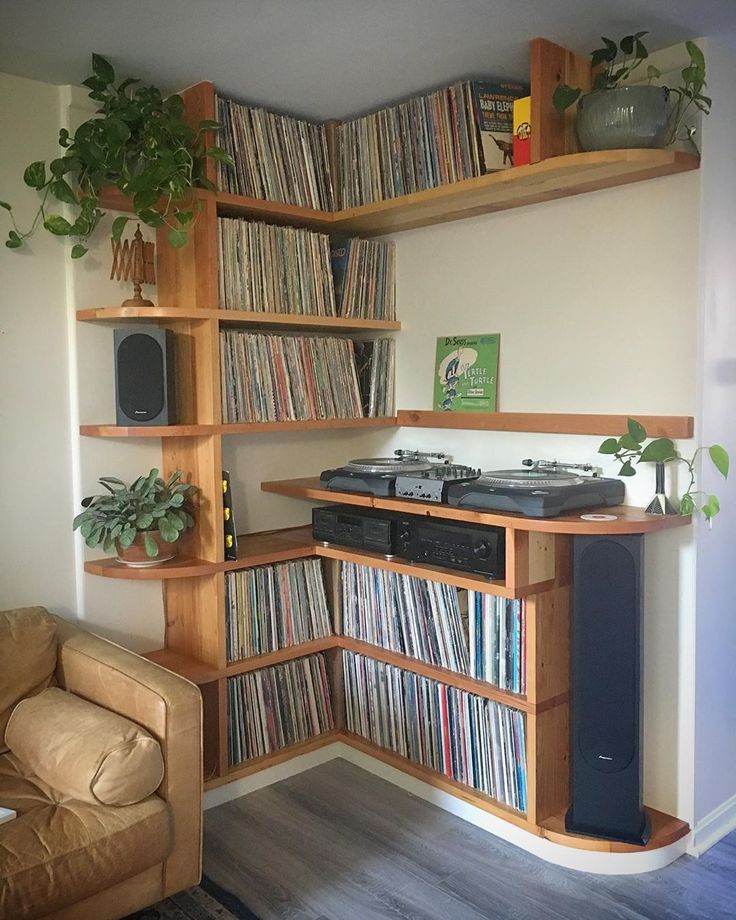 a record player is sitting in front of a shelf full of records