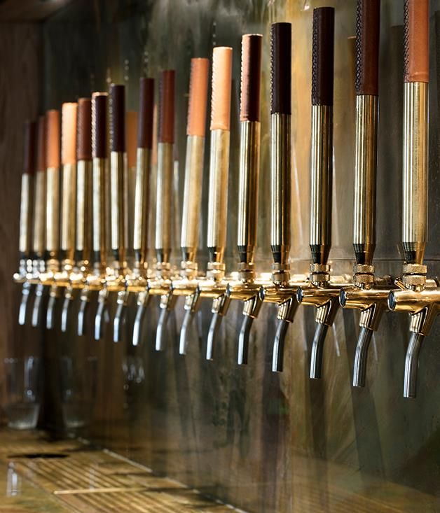 rows of beer taps lined up on the wall