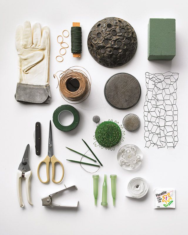 various craft supplies are laid out on a white surface with scissors, thread, and other items