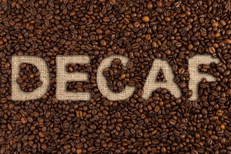 the word decaf written on coffee beans