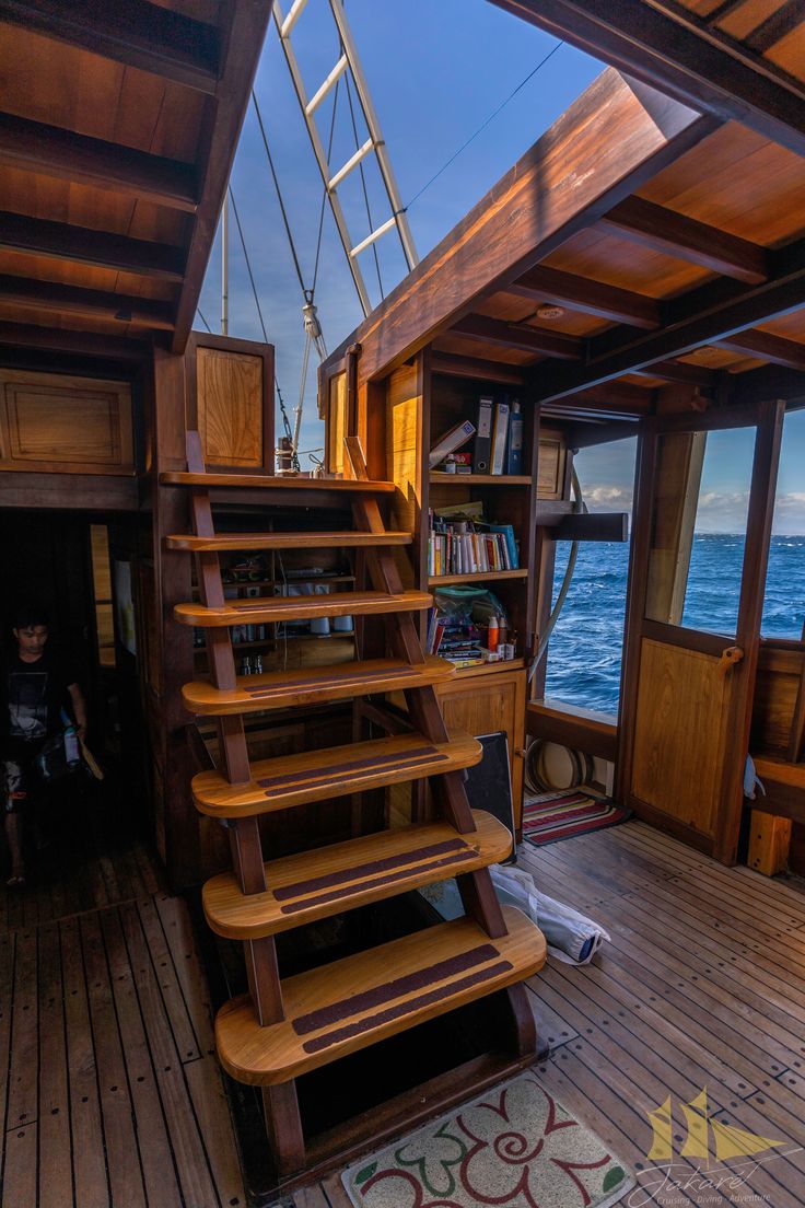 the stairs are made out of wood and have been built into the side of the boat