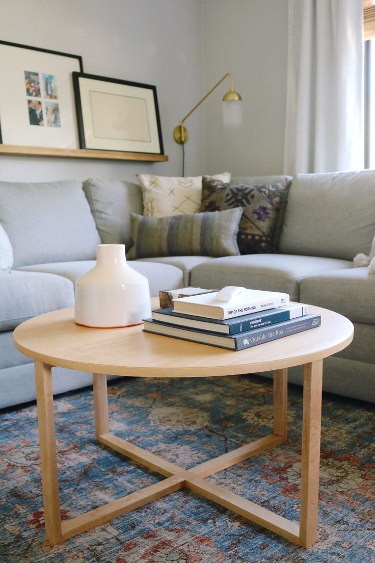 a coffee table with books on it in front of a couch