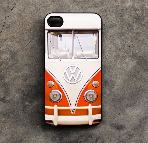 an orange and white vw bus phone case sitting on top of a cement surface
