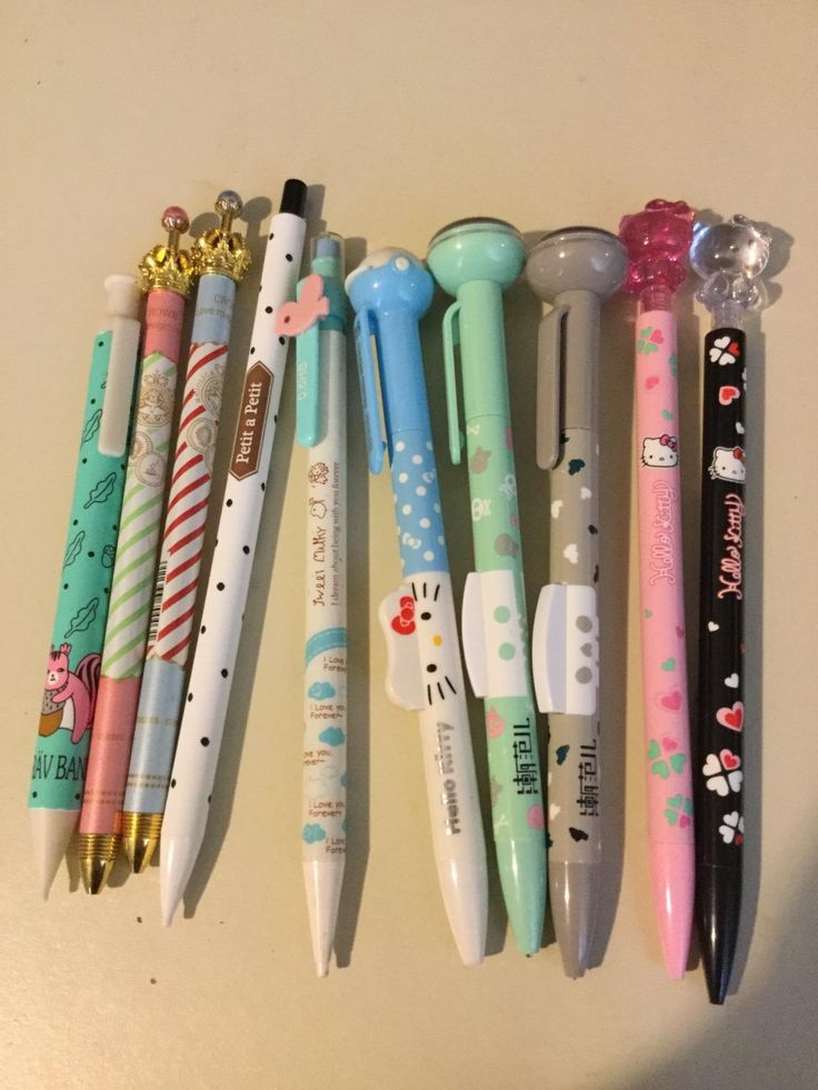 several different types of pens lined up in a row on top of a countertop
