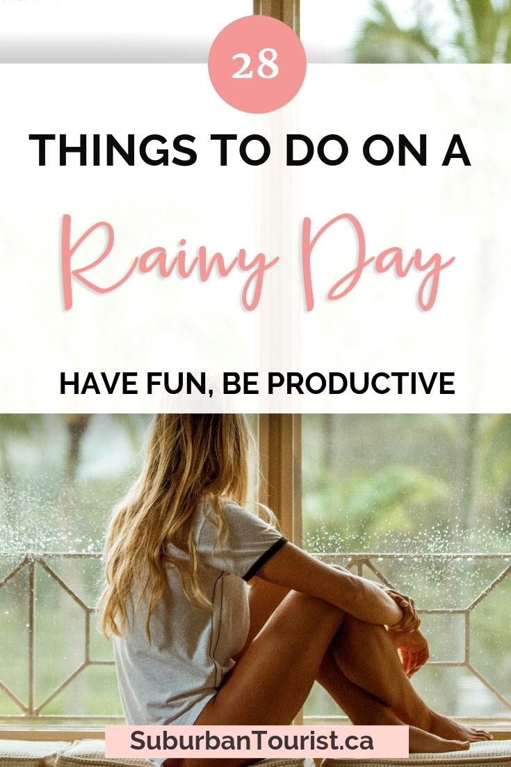 a woman sitting on a window sill with the words 28 things to do on a rainy