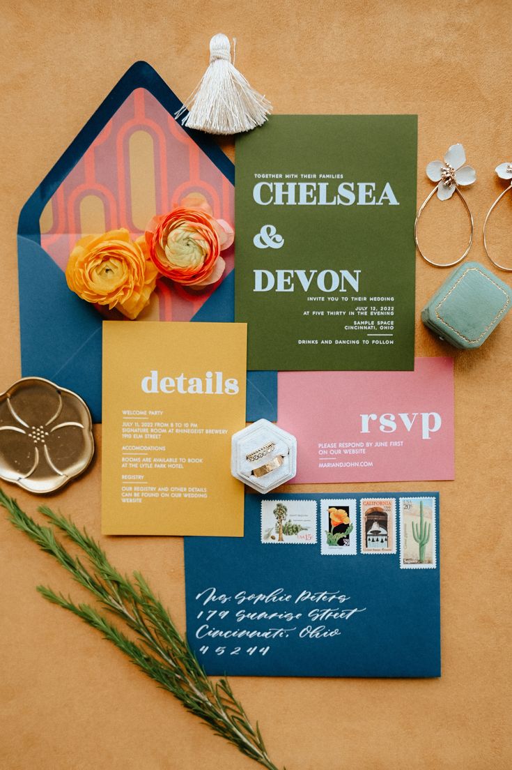 the wedding stationery is laid out on top of each other