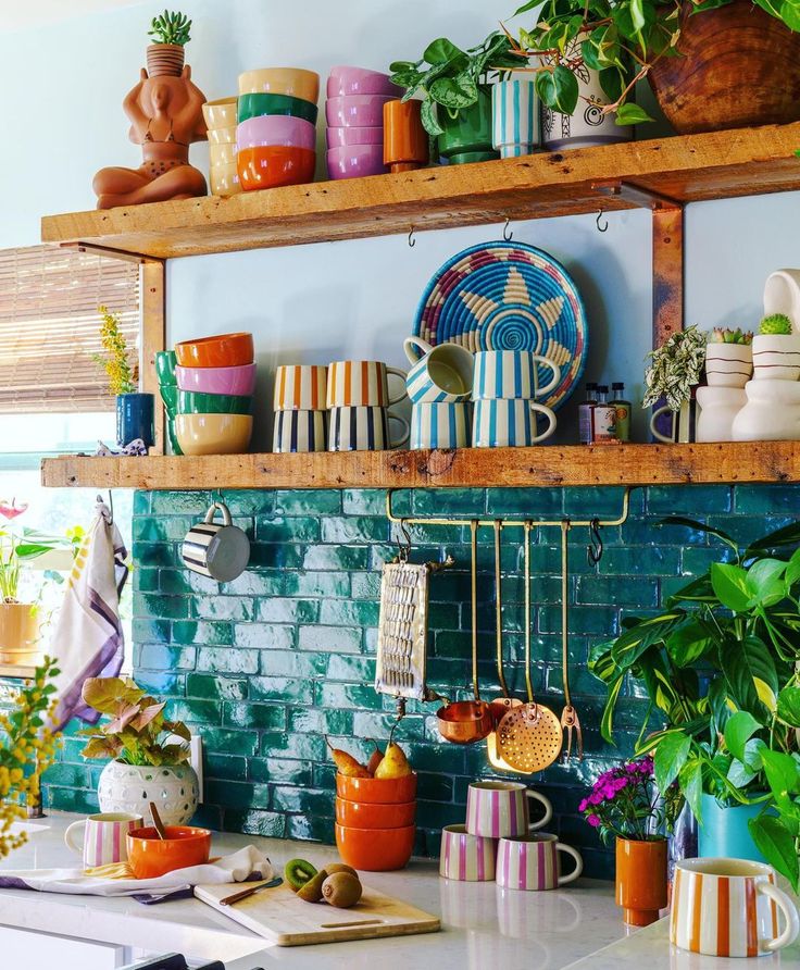 a kitchen counter topped with lots of pots and pans on top of wooden shelves