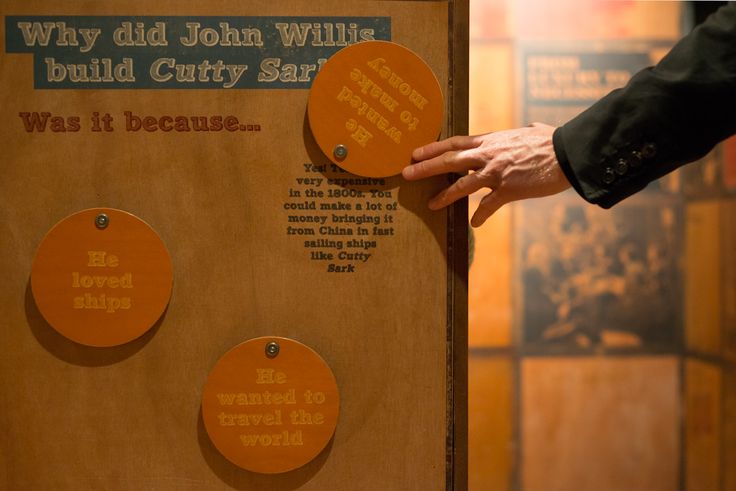 a person is touching the back of a wooden plaque