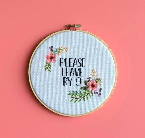 a cross stitch hoop with the words please leave by 9 printed on it and flowers