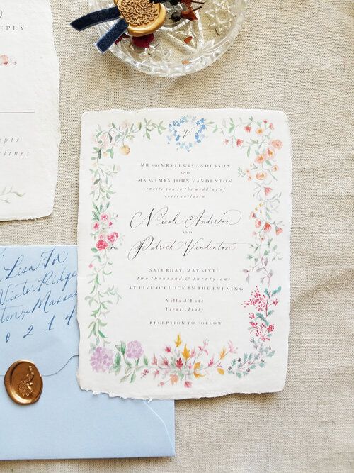 the wedding stationery is laid out on a table