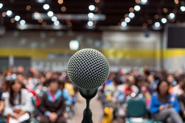 a microphone in front of a large audience