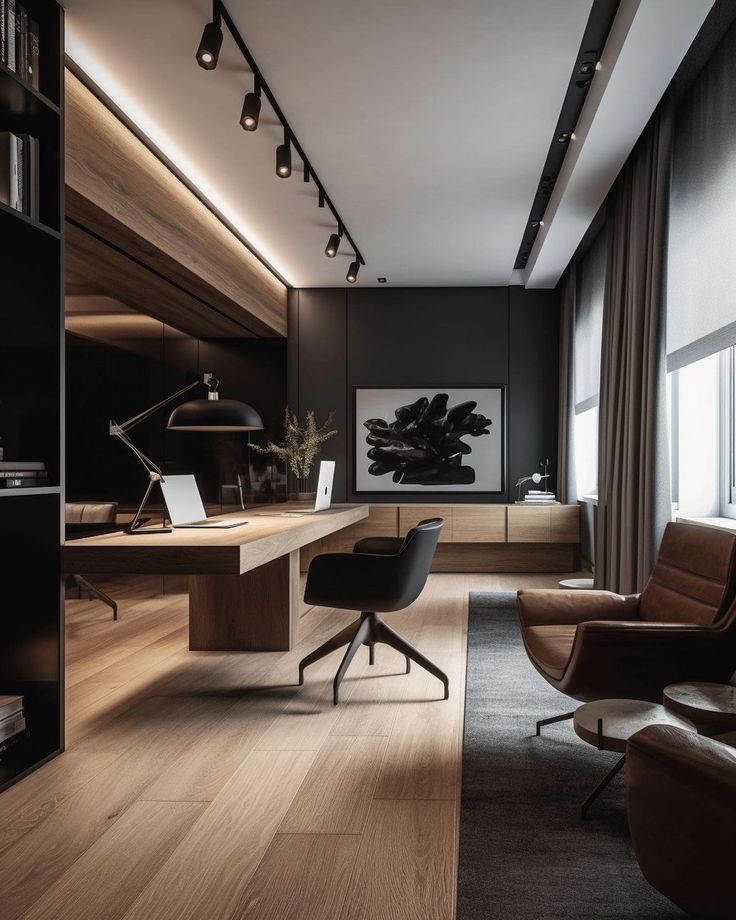 an office with wooden flooring and black walls, along with leather chairs and desks