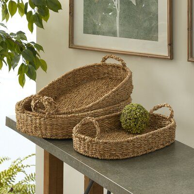 two woven baskets sitting on top of a table