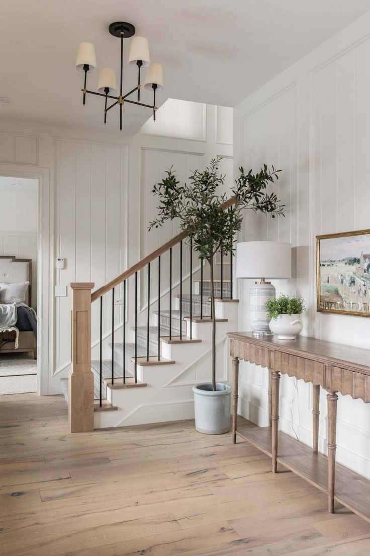 a foyer with white walls and wooden floors