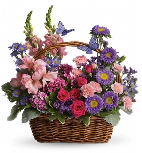 a basket filled with lots of purple and pink flowers