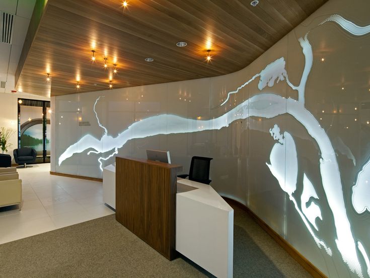 an office lobby with a large glass wall