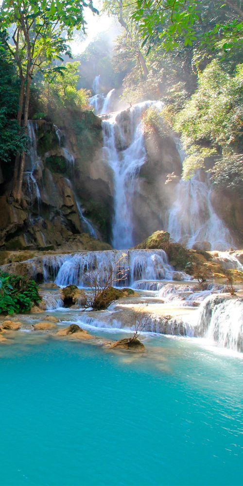 the waterfall is surrounded by blue water