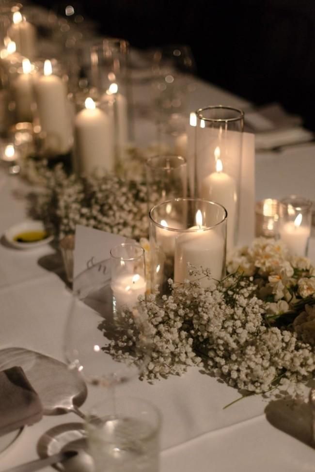 a long table is set with candles and flowers for a formal dinner or wedding reception