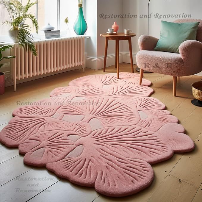 a living room with pink rugs on the floor and furniture in front of a window